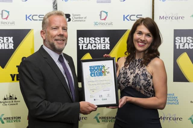 Paul Hills, Sussex Chamber of Commerce, presents Amy Gudgeon of 3D Recruit on behalf of Sue Furness from St Mary Star of the Sea Catholic Primary School, St Leonards, with the Buster's Book Club's Outstanding Performance Award. Picture Submitted by: Martin Apps SUS-180625-165042001
