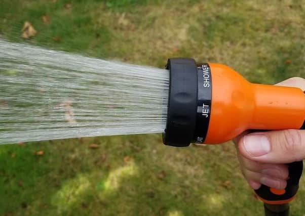 Using hoses and sprinklers in hot weather can use up large amounts of water