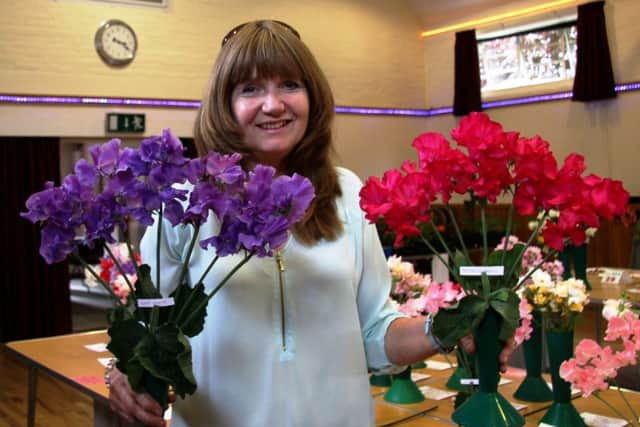 Jayne Pumphrey with two of her winning vases of sweet peas