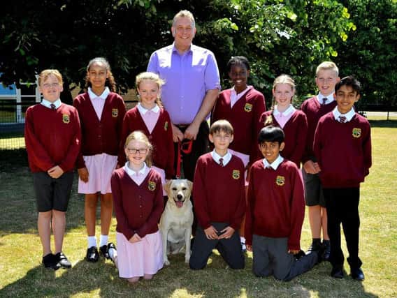 Headteacher Anthony White with some of his pupils and Poppy the school dog