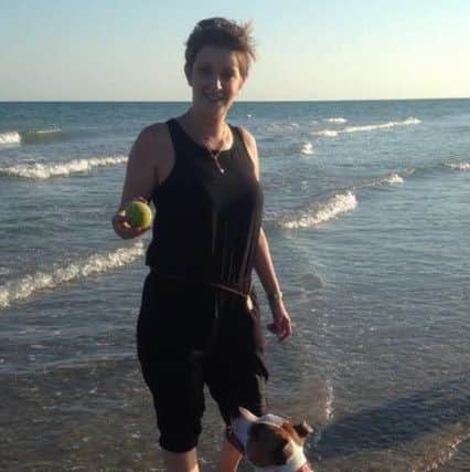 Caroline on the beach with her dogs