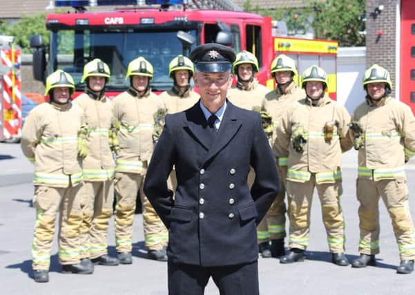 Firefigher Gavin Ross - wearing the uniform he was first issued with 30 years ago