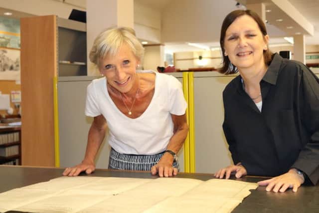 Louise Goldsmith, leader of West Sussex County Council and Wendy Walker, West Sussex County Archivist, with the Sussex Declaration, a copy of the American Declaration of Independence