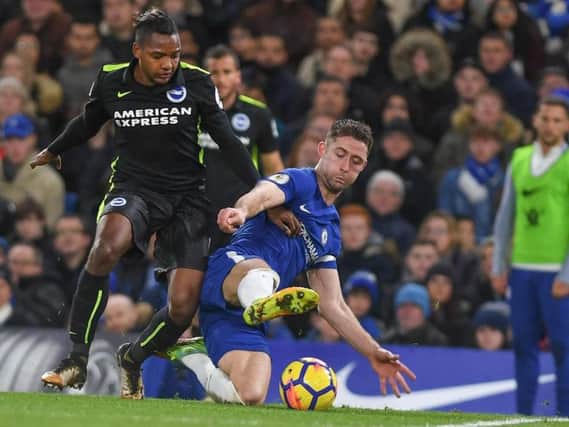 Jose Izquierdo is challenged by England defender Gary Cahill during Albion's 2-0 defeat to Chelsea last season. Picture by Phil Westlake (PW Sporting Photography)