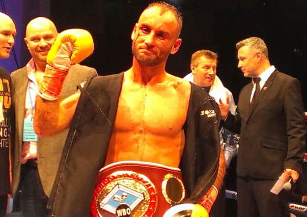 Ben Jones proudly displays his WBO Featherweight Inter-Continental belt after beating Martin Parlagi with a unanimous verdict at the troxy in East London. Picture by Graham Carter SUS-151031-101721002