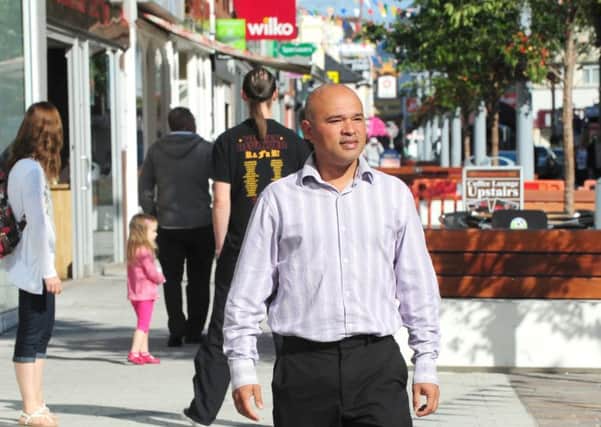 Toyubur Rahman walks through town centre