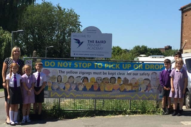 Baird: The Baird Primary Academy pupils and Principal Carly Welch with their new banner SUS-180407-150259001