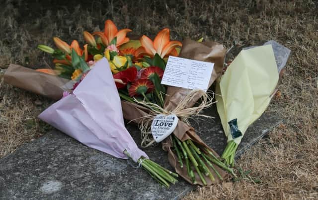 Floral tributes left at the address. Photograph by Eddie Mitchell