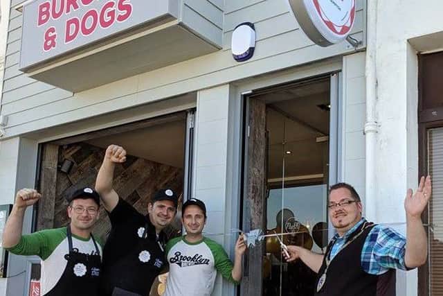 Billy Blanchard-Cooper with the owners of Burgers and Dogs in Littlehampton