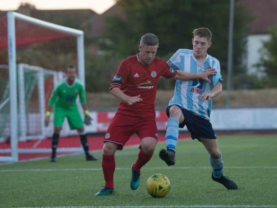 Worthing captain Darren Budd battles for the ball during last night's friendly with Worthing United. Picture by Marcus Hoare