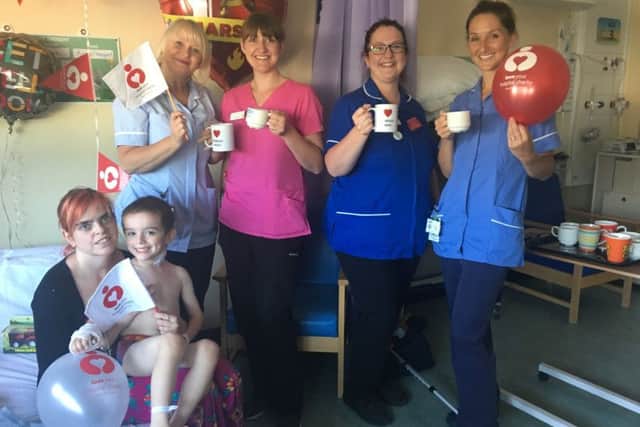 Hannah Jannece and son Riley raise a cuppa with NHS staff on the childrens ward at St Richards Hospital