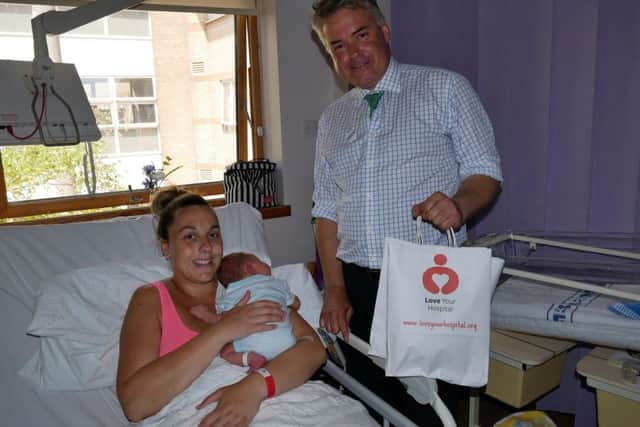 Tim Loughton meets baby Noah with mum Lucy Orton on the maternity unit at Worthing Hospital