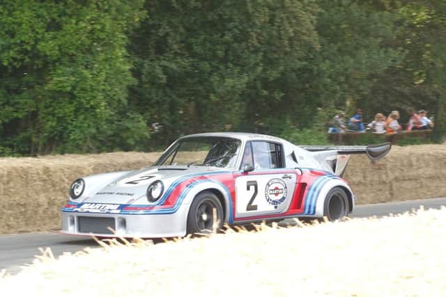 A 1974 Porsche 911 Carrera RSR Turbo in Martini livery on the hill climb at Goodwood. SUS-180716-094216001