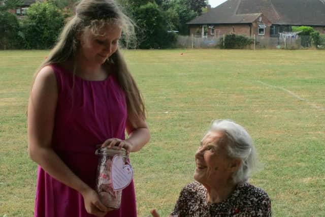 Phyllis Norrell, 'Nan', being given a "Jar of Hearts" by a pupil. Picture contributed