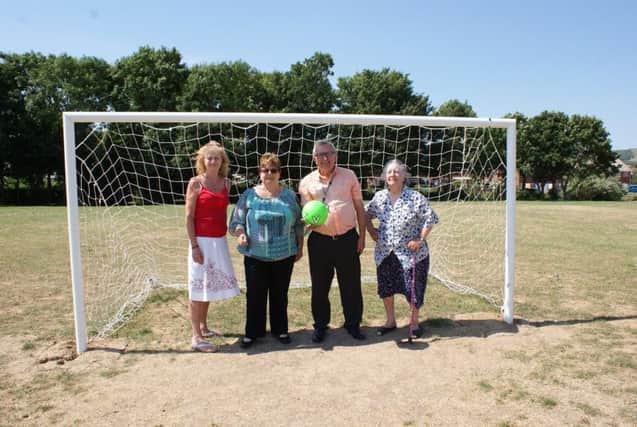 Valerie Thornton (local resident), Councillor Pat Hearn, Councillor Colin Swansborough and Olive Woodall (local resident) with one of the new goal posts SUS-180713-125755001