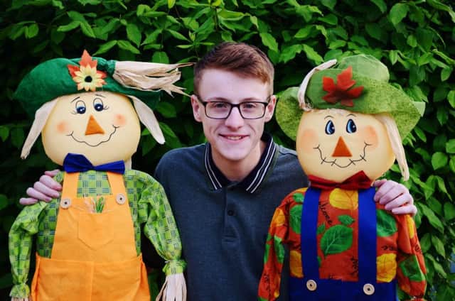 Nathan Dunbar with two scarecrows in Polegate