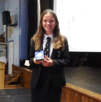 Ava Hudson with her award for year seven sportswoman of the year