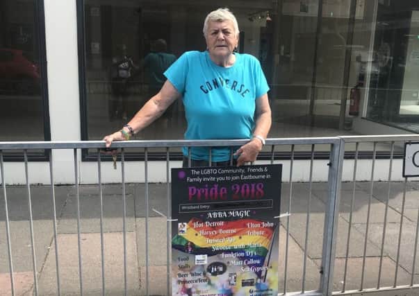 Betty Gallacher, chair of Bourne Out LGBT, with one of the posters