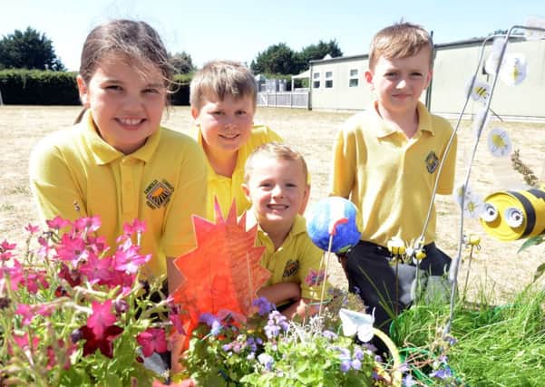 Pupils with some of the beautiful trugs created for a birthday competition, including the Blue Planet winner, centre. Picture: Kate Shemilt ks180351-9