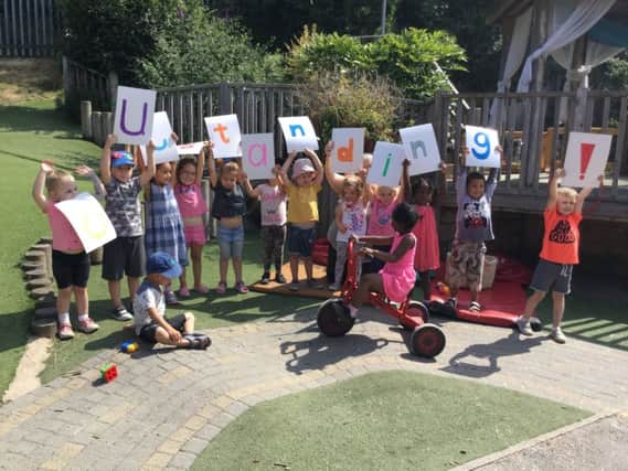 Children at Roundabout Nursery celebrating the Ofsted rating