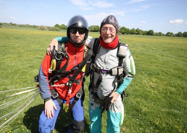 Safely back on solid ground after his skydive,  Jim Knight  (right) and his instructor SUS-180725-150554001