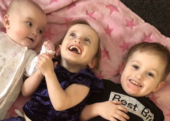 Lola-Grace Brook, centre, with her older brother Leyton Brook and younger sister Alanna-Rose Brook