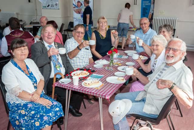 A free family cream tea was held at Wick Hall, Wick Village, Littlehampton to celebrate the start of Wick Week 2018. Pictured: Chairman of Arun District Council, Councillor Alan Gammon, enjoye a cream tea with some local residents at the event. Picture by Scott Ramsey