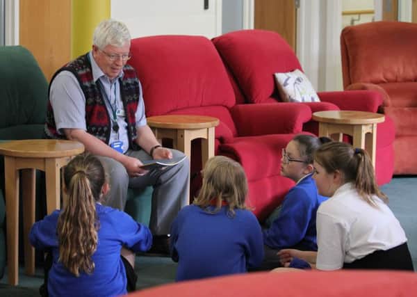 Pupils learning through various exercises, including storytelling, with patients at St Barnabas House hospice