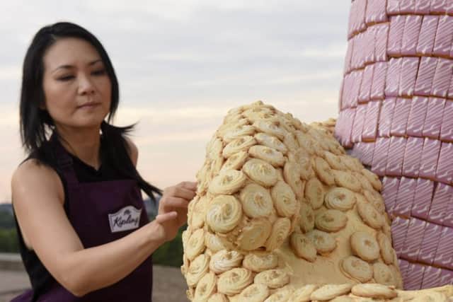 Food artist Michelle Wobowo adds finishing touches to her biggest 3D sculpture yet, one of Roald Dahls most beloved characters; The BFG. Measuring a splendiferous seven metres high and made from over 7,000 individual Mr Kipling cakes, the BFG has been unveiled on top of Primrose Hill to celebrate the new limited edition Roald Dahl themed Mr Kipling cakes.