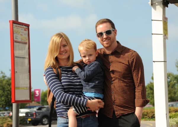 Kevin and Laura Brook with their son Henry, waiting for 'their' bus