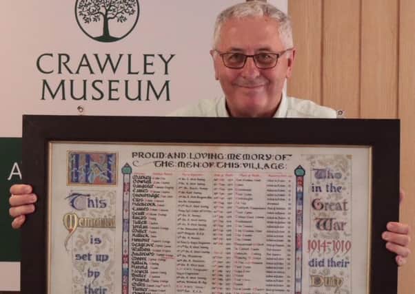 Geraint Thomas and a scroll of those from Lowfield Heath who died in the First World War SUS-180726-161230001