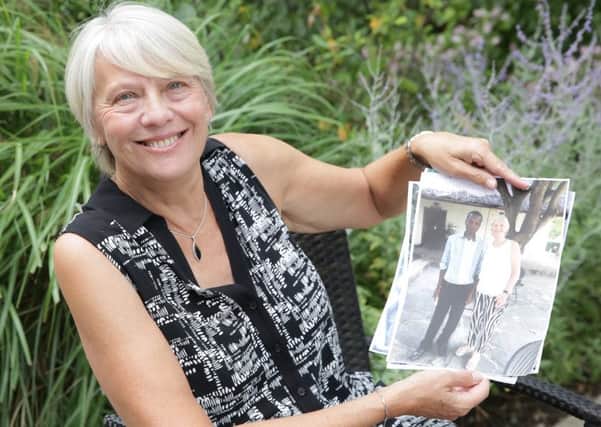 Carol Groves with photographs from her time in Mombasa