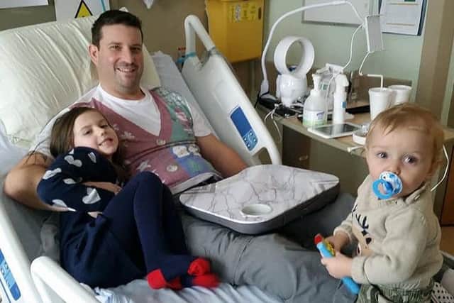 Alan Barrett, from Littlehampton, is cycling to raise funds for his brother-in-law who has been left paralysed from the waist down after falling from the roof of his Canadian home. Pictured is Brian in hospital in Canada with his children