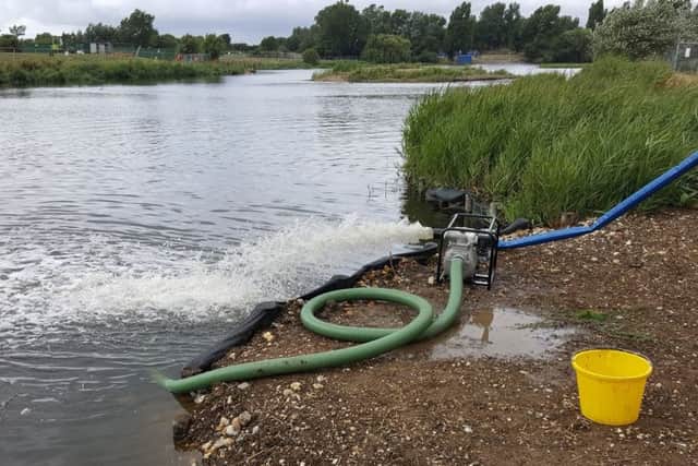Council staff working to aerate the water at Brooklands Lake SUS-180730-145917001