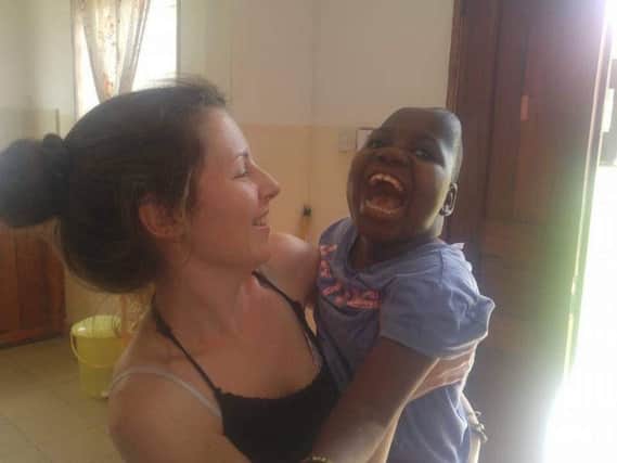 Daisy King, co-founder of Thrive Village, with nine-year-old Lucia from Tanzania SUS-180731-125717001