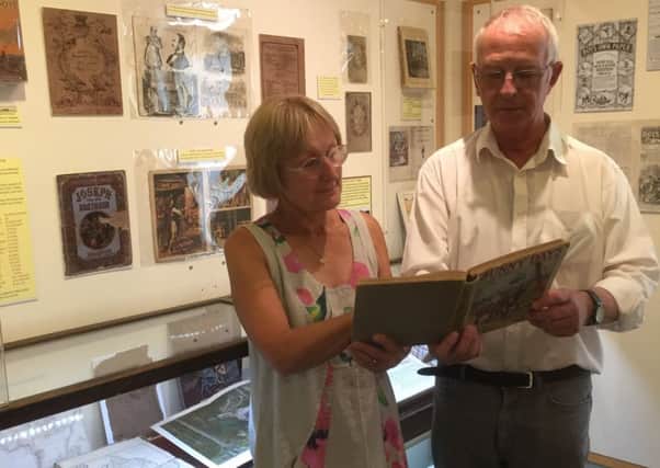 Andrew Woodfield and Linda Aitken examine one of the books on display