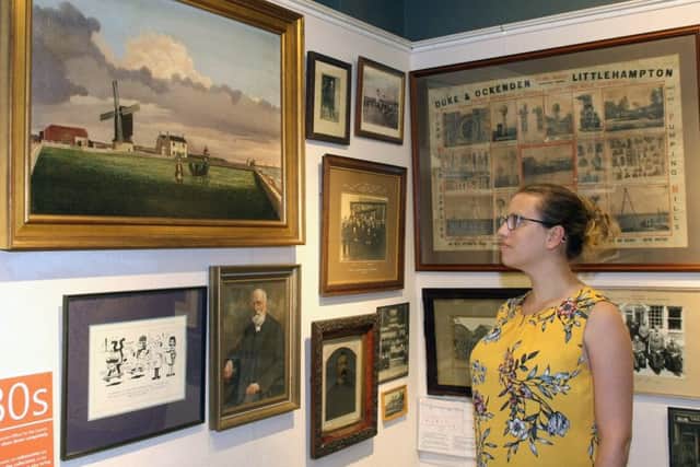 Exhibitions officer Lucy Ashby with some of the pictures on display. Picture: Derek Martin DM1880807a