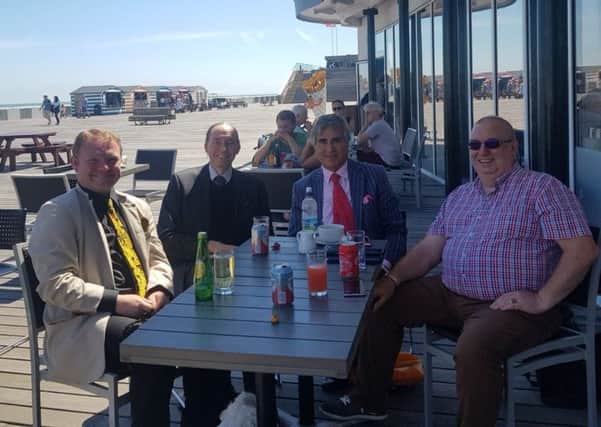 The chairman of the National Piers Society (second from left) met with Sheikh Abid Gulzar on Hastings Pier. Picture supplied by Brett McLean