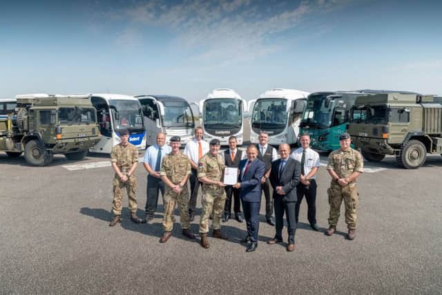 Front row, from left, engineering workshop manager Dave Nestor, Thorney Island station commander Lt Col Ian Coulson, Lucketts Group managing director Tony Lawman and operations director Dave Allen with, back row, drivers of the Lucketts coaches and military vehicles