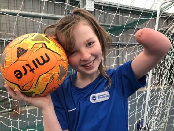 Football-mad ... talented youngster Tate Willis was born with part of her left arm missing