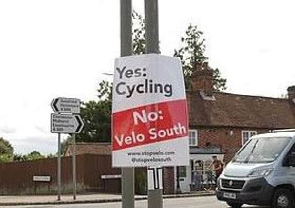Posters have been put up by campaigners hoping to stop Velo South, a 100-mile cycling event.