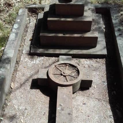 The grave of Frank Foster Talbot Todd features a wheel within a cross, a poignant reminder of his terrible death