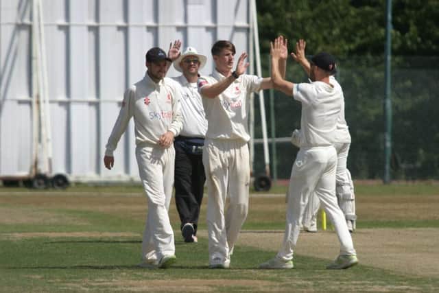 Horsham's George Garton celebrates the wicket of Hastings' Tom Gillespie. Photo by Clive Turner