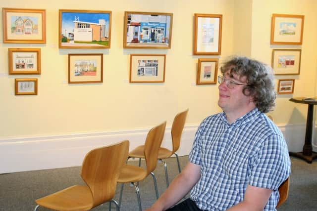 Collections documentation officer Jonathan Parrott in the Butterworth Gallery, which is filled with pictures by Littlehampton artist Rad Radburn. Picture: Derek Martin DM1880830a