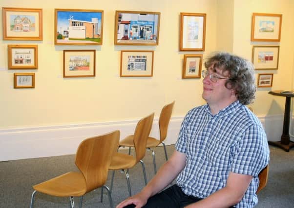 Collections documentation officer Jonathan Parrott in the Butterworth Gallery, which is filled with pictures by Littlehampton artist Rad Radburn. Picture: Derek Martin DM1880830a