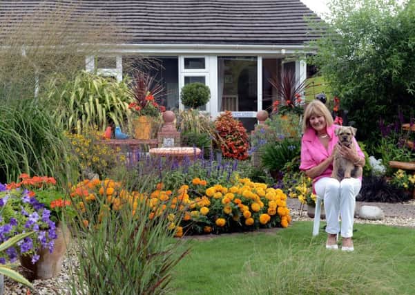 Winner 
Liz Blake with Dilly in her award-winning garden in Penlands Vale, Steyning. Picture: Kate Shemilt ks180389-2