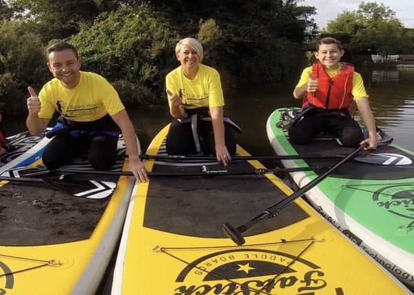 Rachael Davis paddleboarding with husband Mark and 14-year-old son Alfie
