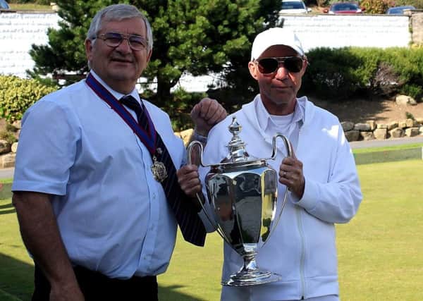 John Ruff receives the men's singles trophy from Cllr Nigel Sinden at the 2017 Hastings Open Bowls Tournament. Picture courtesy Bob Bogie
