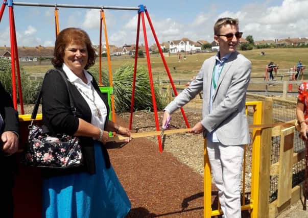 The mayor of Seaford cllr Wallraven and former young mayor Thomas Exley officially open the wheelchair swing in Seaford. SUS-180813-161313001