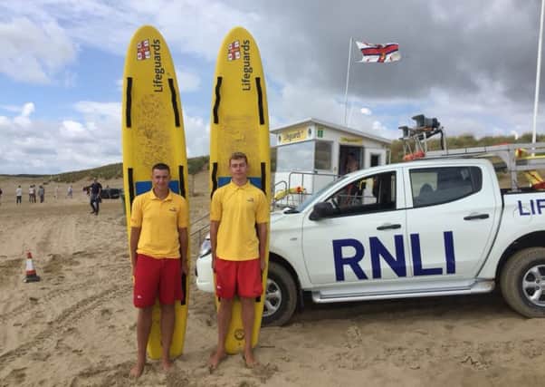 RNLI lifeguards Tom Bedford (left) and James Blything (right) on Camber Sands. Picture: RNLI/Dominic Richard